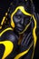Yellow and black body paint. Woman with face art. Young girl with bodypaint. An amazing model with makeup.