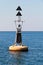 Yellow black North Cardinal buoy is on water