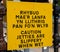 Yellow and black sign warning of slippery jetties in English and Welsh Llandudno North Wales May 2019