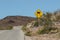 Yellow and black slippery sign along a road