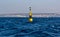 Yellow and black steel navigational floating buoy