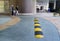 Yellow and Black Striped Speed Bump in residential area in family and pedestrian and granite pavement Background, Mid-Day