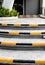 Yellow and black stripes as safety symbols at the edge of the stairs