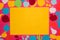 yellow blank paper around which is a pink background with colorful fruit, healthy background, creative summer design