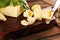 Yellow block of fresh butter sliced on wooden cutting board and butter swirls. Slices of margarine or spread, fatty natural dairy