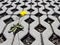 A yellow blooming dandelion flower sprouts between latticed concrete slabs in the daytime. Life conquers death and civilization. D