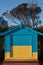 A yellow-blue bathing box at the Brighton Beach in Melbourne