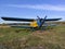 Yellow and blue old biplane plane with a single piston engine and propeller