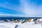 Yellow, blue, red and green inuit houses covered in snow at the