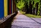 Yellow, blue and red steel picket fence and sidewalk in diminishing perspective