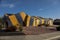 Yellow and blue striped termite tent covering a ranch style house