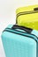 Yellow and blue suitcases, close up.