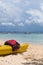 A yellow boat with red life jackets lies on the sand. Beach on Manukan Island, Sabah, Malaysia