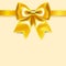 Yellow bow of silk ribbon, isolated on yellowish background
