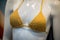 yellow bra of bikini on mannequin in a fashion store showroom