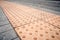 Yellow Braille blocks on public transport station for person with a physical disability