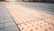 Yellow Braille blocks on public transport station for person with a physical disability