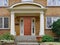 Yellow brick house with large portico