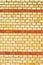 Yellow brickwall with red stripes