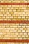 Yellow brickwall with red stripes