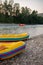 Yellow bright boats for rafting on the bank of a mountain river. against the background in the distance is a wooded mountain shore