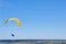 Yellow bright bright Paraglider in blue sky above the river and riverside. Bird`s eye panorama. Tom river. Tomsk city, Russia