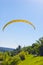 Yellow bright bright Paraglider in blue sky above the river and riverside. Bird`s eye panorama. Tom river. Tomsk city, Russia