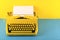 Yellow bright typewriter on a yellow background. Creativity concept