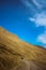 Yellow-Brown Desert Mountain in Spiti Valley against plain blue sky. Serene martian-looking background landscape. Solo Travel.