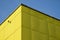 Yellow building is lined with square panels of plastic, fiberglass. fastened with screws. Washable walls is a major advantage. on