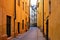 Yellow buildings on a narrow cobblestone street in Gamla Stan, the Old Town of Stockholm, Sweden