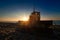 Yellow Bulldozer on Beach at Sunrise