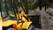 Yellow bulldozer scoop picks up