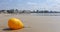 Yellow buoy on the beach