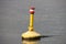 Yellow buoy in the river Hollandsche IJssel to characterize danger