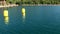 Yellow buoys on water surface view from a moving sailing yacht .