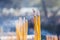 Yellow burning incense sticks outdoor