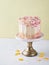 Yellow buttercream ombre birthday cake with colorful sprinkles over yellow background with copy space. Romantic love concept.