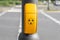 Yellow button for blind, disabled or handicapped people on traffic lights to get an acoustic signal when traffic light is green to