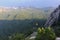 The yellow cab of the funicular climbs the Ai Petri mountain in the Crimea. Top-down view of the mountains, forest and sea