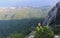 The yellow cab of the funicular climbs the Ai Petri mountain in the Crimea. Top-down view of the mountains, forest and sea