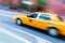 Yellow cab in NYC in motion blur