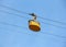 Yellow cabin ropeway on blue sky background