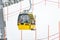 Yellow cable car on Alpine ski slope