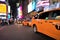 Yellow cabs and people in NYC near Times Square at night