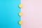 Yellow cakes on blue and pink background