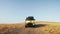 A yellow campers van rides off-road in summer morning