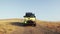 A yellow campers van rides off-road in summer morning