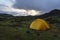 Yellow camping tent in an open moss field during sunset. Shot on adventure in Icelandic highlands