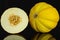 Yellow canary melon isolated on black glass